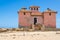 Large pink ruined mansion from Portuguese colonial times in Angola