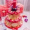 Large pink two-tiered cake with a unit on top for a children`s birthday