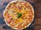Large pizza pan with delicious tomatoes and cheese.Italian style pizza, thin crispy batter with tomatoes and cheese