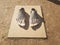 Large plaster cast of feet on wood board outdoor