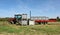 Large plastic bulk bins used for storage and transporting grapes in front and on the tractor trailer