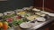 Large plates with salads and appetizers on a buffet