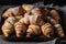 large platter of croissants, dusted with powdered sugar and filled with creamy, rich chocolate