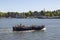 A large pleasure boat with tourists on the Amstel River in Amsterdam.