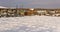 Large plot of land in the village, covered with snow,illuminated by the sun