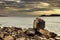 Large pointed stone among the rocky formations by the sea