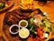 Large pork ribs with fries and salad with different sauces