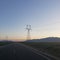 Large powerlines over two lane asphalt road