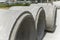 Large precast concrete pipe segments prepared on a road for sewage, storm drain or water supply project