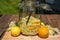 In the large preserving jar on the cutting board are the fresh elderflowers, oranges and lemon slices and the vanilla pod