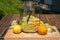 In the large preserving jar on the cutting board are the fresh elderflowers, oranges and lemon slices and the vanilla pod
