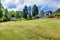 Large property with blue house and trees.