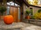 Large pumpkin standing at the front doors outside of the fancy home. Season outdoor decoration for the halloween in USA