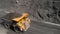 Large quarry dump truck. Loading rock in dumper. Loading coal into truck. Mining car machinery to transport coal. Open