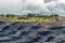 A large quarry with many horizons and ledges. Vertical bedding of coal seams.