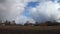 Large rain clouds in the sky over an abandoned village. Cloudy weather, time-lapse.