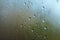 Large raindrops on fogged glass