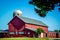 Large Red Barn With White Windows and Silo