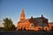 A large red brick church in the final rays of the sun