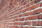 Large red brick wall. Side view. Perspective