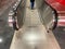 Large red modern long bright underground walkway between metro stations with travel walkers and escalators for quick passage of