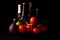 Large red and ripe tomatoes with lime avocado and bottle of beer on black background