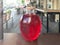 A large red transparent glass round luminous bright can with a wooden lid, a container with delicious sweet juice, a hamper, a mor