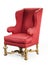 Large red wing chair upholstered in red old antique in need of r