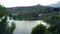 Large reservoir lake in the mountains, very blue water, pine trees on the shore, beautiful landscape, Beniarres, Spain