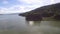 Large reservoirs of water hydro electric dam submerging part of the mountain side. aerial drone shot