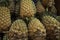 Large ripe juicy pineapples on the counter. A lot of pineapples background.