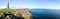 A large rock tower sits near a coastal cliff in Scotland