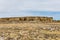 Large rock wall along desert vista landscape in rural New Mexico