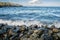 Large rocks on the beach at Neck Point Park spit, Nanaimo, British Columbia, Canada on a windy and sunny day in November