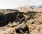 Large rocks and canyon with mountains beyond, Fissile Falls, California