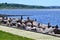 Large rocks and numerous small inukshuks along Annapolis Royal boardwalk with bay and lush forested hills on the horizon