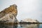 Large rocks in the ocean and flock of birds