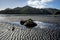 Large rocks in pool of water with cloud reflection at North Taranaki, New Plymouth