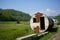 Large round abandoned container in the meadow