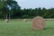 Large round hay bale in field