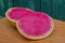 A large round piece of cut red radish lies on the table