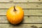 Large round pumpkin on wooden rustic background top view