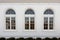 large rounded windows on a white italianate building