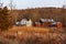 Large rural country home and red barn in dry winter landscape