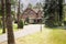 Large, rural estate with brick facade and green lawn standing in