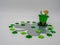 Large Rustic Metal Four Leaf Clover with a Green Sparkly Leprechaun hat and a bunch of green sparkly four leaf clovers on a white