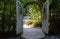 The large rustic wooden door on the stone pathway