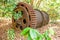 Large rusty gear of Tin Dredge in the deserted tin mine. Dry leaves fall on the ground, tropical forest backgrounds