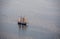 A large sailboat goes to sea under sail. View from above.