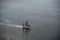 A large sailboat goes to sea under sail. View from above.